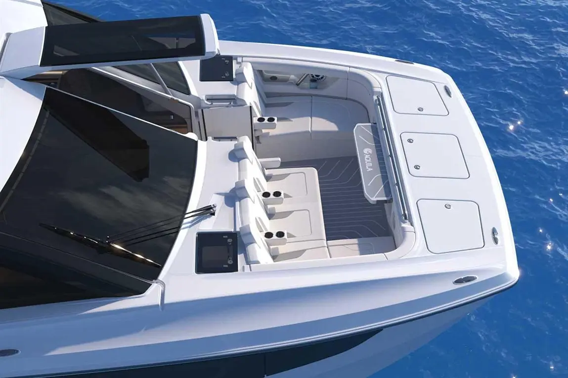 Aerial view of a modern boat deck featuring sleek seating, cup holders, and a logo, surrounded by calm blue water.